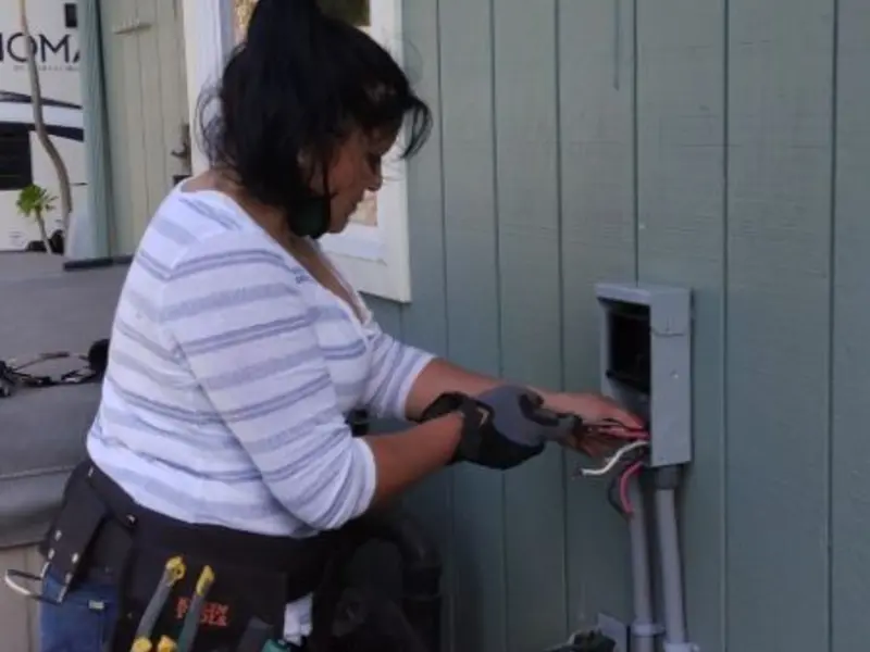 Licensed electrician wiring an exterior subpanel in Borger
